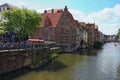Row of medieval buildings along the Lys River. Little square with Big cannon The Mad Mag Royalty Free Stock Photo